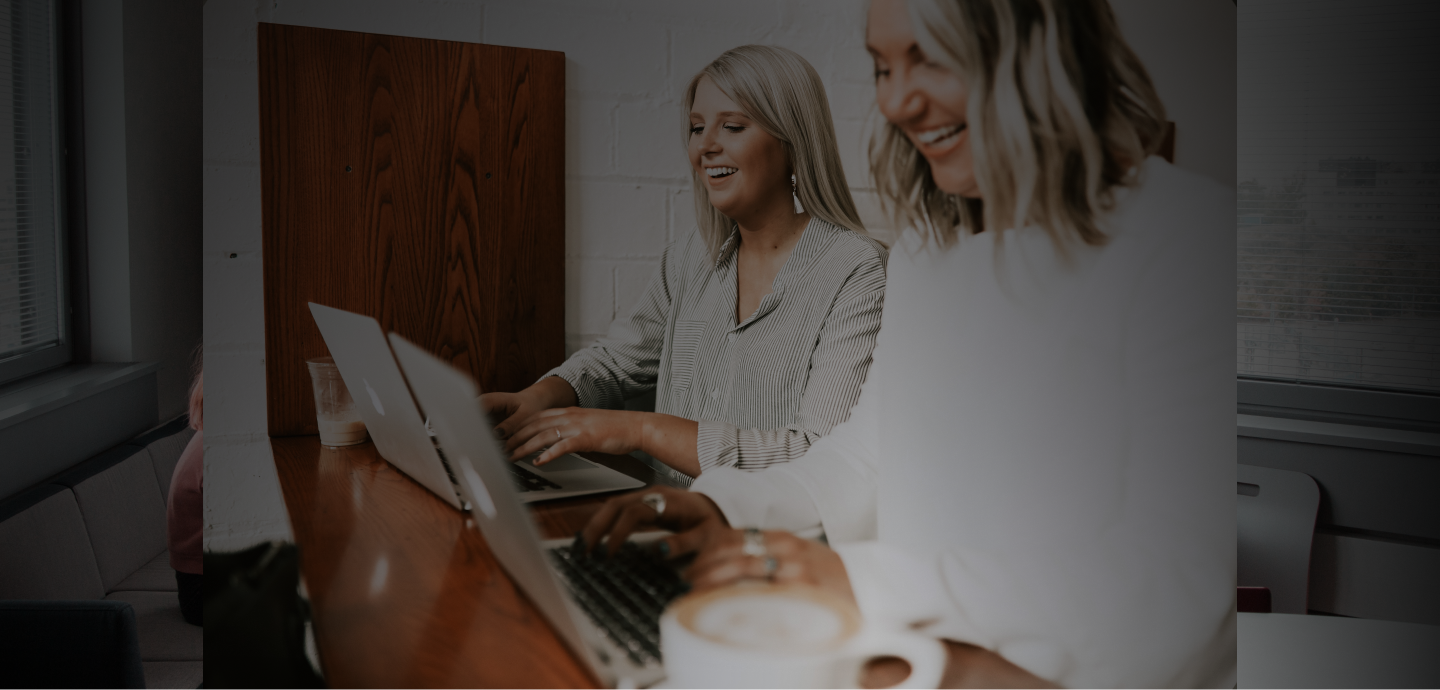 Receptionnists at reception laughing and happy