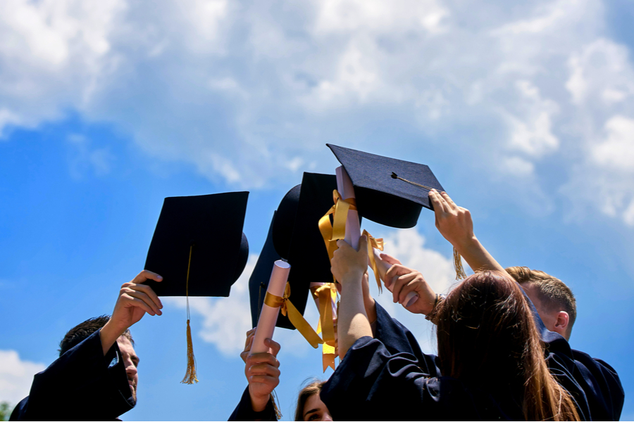 Graduates throwing their caps in the air